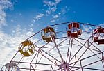 Close Up Part Of Pastel Ferris Wheel On Blue Sky Stock Photo