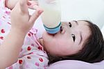 Closeup Cute Asian Girl Suck Up Milk Bottle. Drinking Milk For Good Healthy Stock Photo