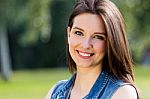 Closeup Portrait Of Cute Young Woman In The Park Stock Photo