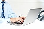 Closeup Shot Of Man Working On A Laptop Stock Photo