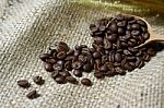 Coffee Beans In Wooden Spoon On Sackcloth Stock Photo