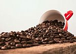 Coffee Cup And Beans On Wood Background Stock Photo