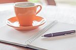 Coffee Cup, Pen And Notebook On Wooden Table Stock Photo