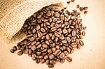 Coffee Roasted Bean In The Sack On Wooden Background Stock Photo