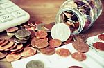 Coins Spilling Out Of A Glass Bottle Vintage Stock Photo