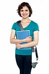 College Student With Stylish Sling Bag And Notebook Stock Photo