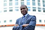 Confident Businessman With Arms Crossed Stock Photo