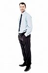 Confident Businessman With Hands In Pockets Stock Photo