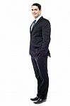 Confident Businessman With Hands In Pockets Stock Photo