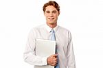 Confident Corporate Man Holding Laptop Stock Photo