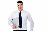 Confident Corporate Man Holding Laptop Stock Photo