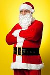 Confident Male Santa Posing With Arms Folded Stock Photo