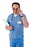 Confident Senior Doctor With File Stock Photo