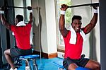 Confident Young African Guy Working Out In Gym Stock Photo