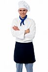 Confident Young Chef With Arms Crossed Stock Photo