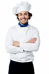 Confident Young Cook Posing In Uniform Stock Photo