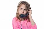 Confused Girl Speaking Over Phone Stock Photo