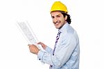 Construction Engineer Studying The Plan Stock Photo