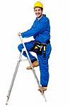 Construction Worker Climbing Up The Step Ladder Stock Photo