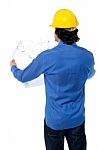 Construction Worker With Blueprint Plan Stock Photo