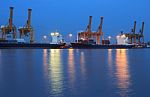 Container Cargo Freight Ship With Working Crane Bridge In Shipyard Stock Photo