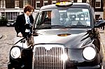 Corporate Guy Interacting With Taxi Driver Stock Photo