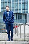 Corporate Guy Walking Down The Stairs Stock Photo