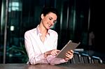 Corporate Lady Operating New Tablet Device Stock Photo