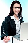 Corporate Lady Posing With Pen In Hand Stock Photo