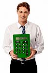 Corporate Man Showing Big Green Calculator Stock Photo