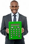 Corporate Man Showing Big Green Calculator Stock Photo