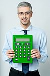 Corporate Man Showing Calculator Stock Photo