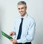 Corporate Man Using Calculator Stock Photo