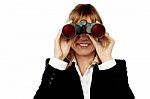 Corporate Woman Looking Through Binoculars Stock Photo