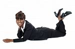 Corporate Woman Lying On Floor, Smiling Stock Photo