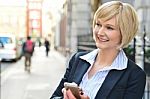 Corporate Woman Operating Her Cellphone Stock Photo