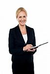 Corporate Woman Writing On Clipboard Stock Photo