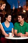 Couple Enjoying Coffee In Cafe Stock Photo