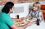 Couple Enjoying Dinner At A Restaurant Stock Photo