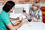 Couple Enjoying Dinner At A Restaurant Stock Photo