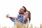 Couple Enjoying The Breeze In The Park Stock Photo