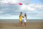 Couple Flying Kite Stock Photo