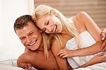 Couple In Bed Laughing Stock Photo