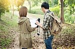 Couple Of Tourists Heading To The Forest With Maps In Hand Searc Stock Photo