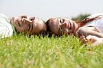 Couple Relaxing On Lawn Stock Photo