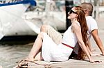 Couple Seated On Footbridge Stock Photo