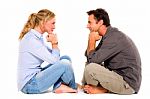 Couple Sitting Face To Face Stock Photo