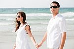 Couple Walking On The Beach Stock Photo