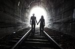 Couple Walking Together Through A Railway Tunnel Stock Photo