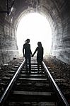 Couple Walking Together Through A Railway Tunnel Stock Photo